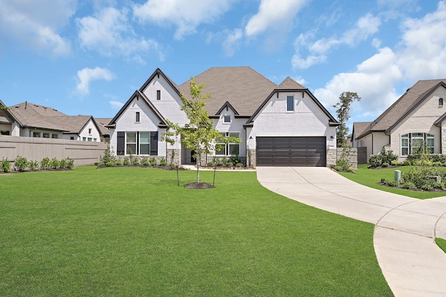 view of front of property with a garage and a front lawn