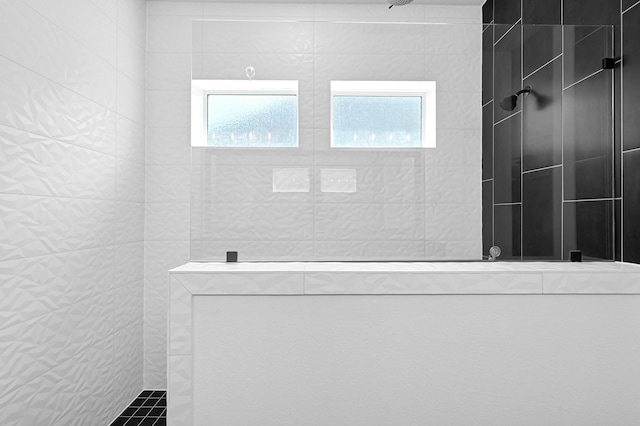 bathroom with tiled shower