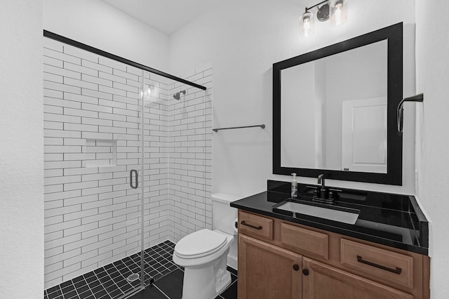 bathroom featuring vanity, a shower with shower door, and toilet