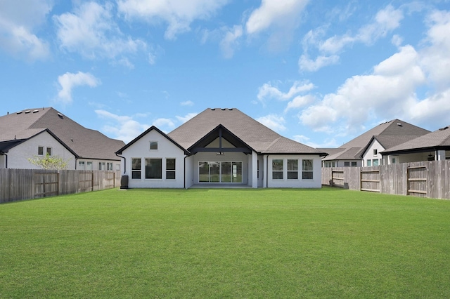 rear view of property with a lawn