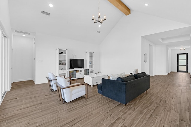 living room featuring an inviting chandelier, light hardwood / wood-style floors, and beamed ceiling