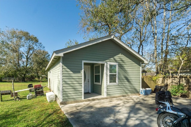 rear view of property with a lawn and a patio