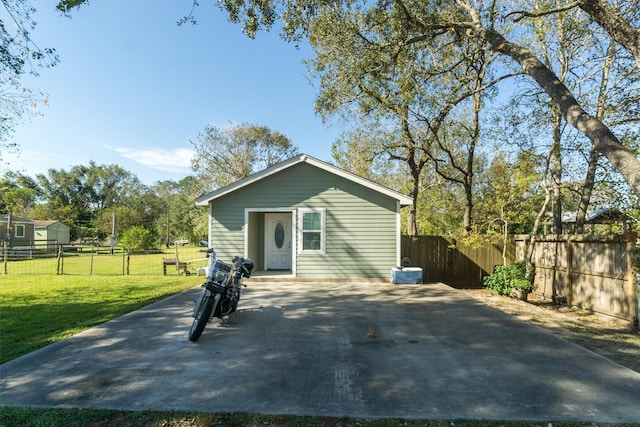 back of house with a lawn