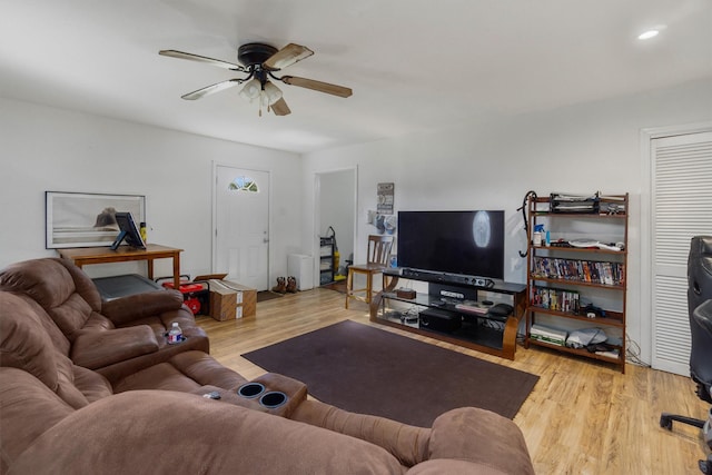 living room featuring ceiling fan and light hardwood / wood-style flooring