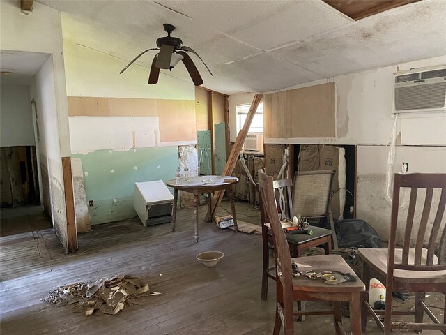 interior space with a wall unit AC, a textured ceiling, cooling unit, ceiling fan, and wood-type flooring