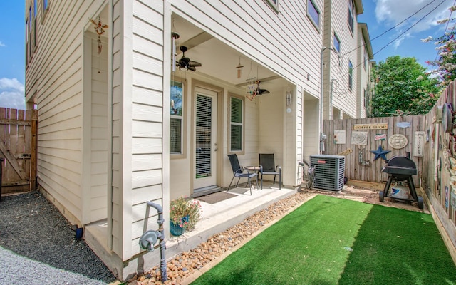 exterior space with central AC unit, ceiling fan, and area for grilling