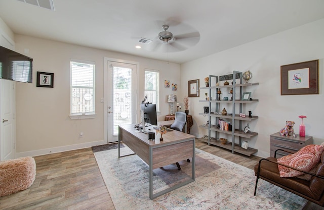 home office featuring light wood-type flooring and ceiling fan