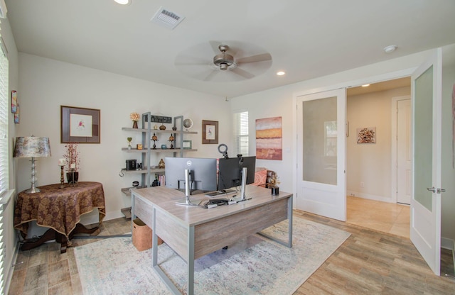 office area with ceiling fan, light hardwood / wood-style flooring, and french doors