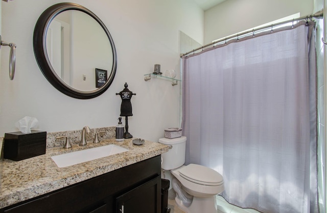 bathroom with vanity, toilet, and walk in shower