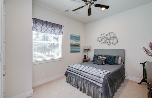 bedroom with ceiling fan and light colored carpet