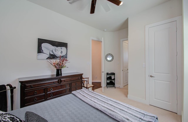 bedroom featuring ceiling fan and light carpet