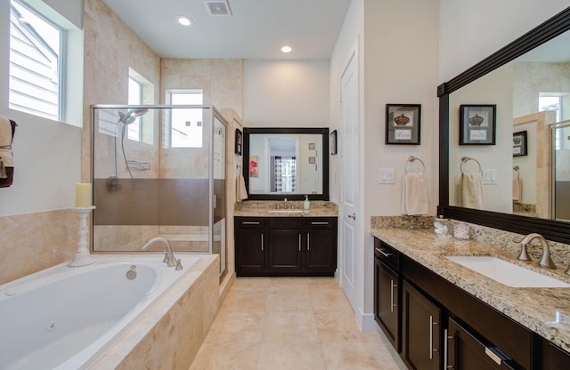 bathroom with separate shower and tub, plenty of natural light, and vanity