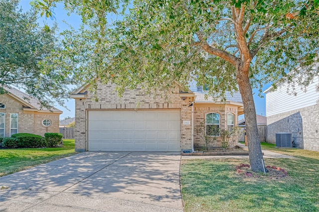 view of front of property featuring a garage, cooling unit, and a front lawn