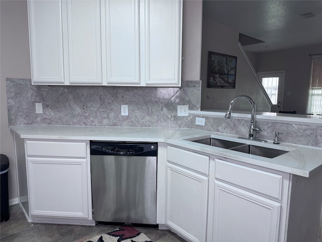 kitchen featuring sink, stainless steel dishwasher, dark tile patterned floors, and tasteful backsplash