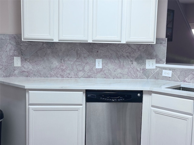 kitchen featuring decorative backsplash, white cabinetry, light stone countertops, and stainless steel dishwasher