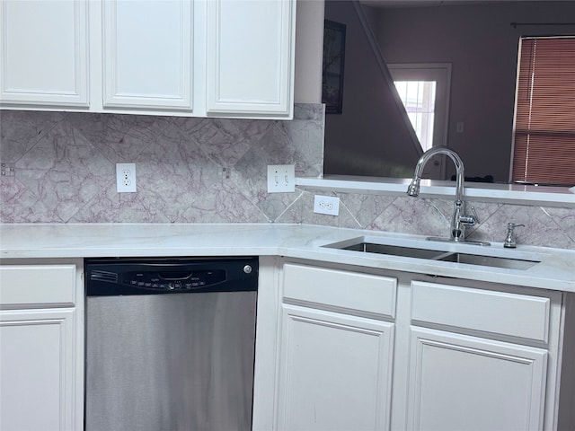 kitchen featuring white cabinetry, dishwasher, backsplash, and sink