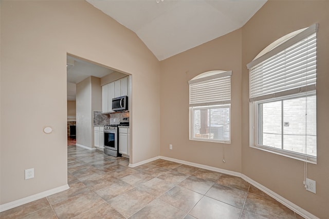 unfurnished living room featuring light tile patterned floors and vaulted ceiling