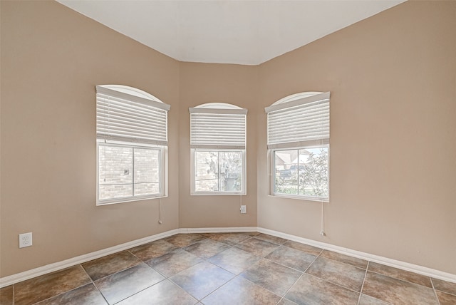 unfurnished room featuring tile patterned flooring