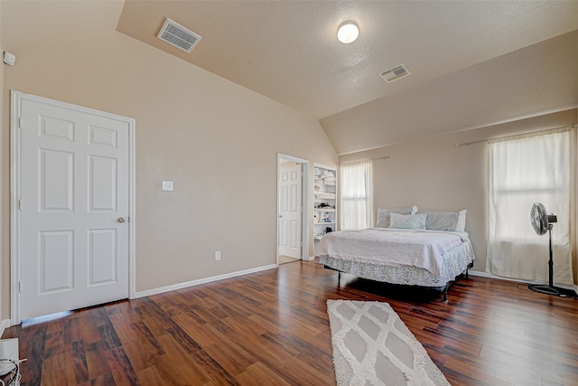 bedroom featuring hardwood / wood-style flooring and lofted ceiling