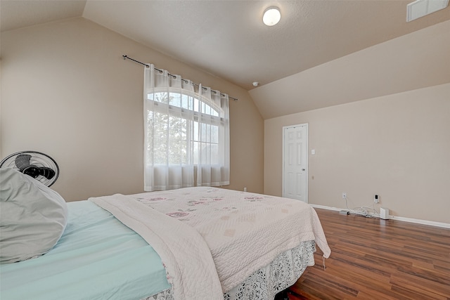 bedroom featuring hardwood / wood-style flooring and lofted ceiling