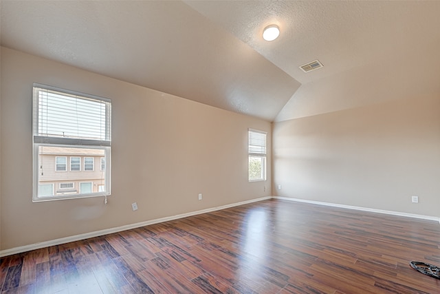 unfurnished room with vaulted ceiling and hardwood / wood-style floors