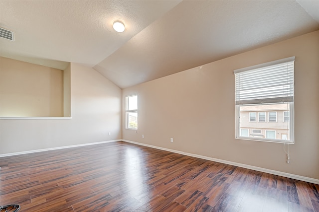 unfurnished room featuring wood-type flooring and vaulted ceiling