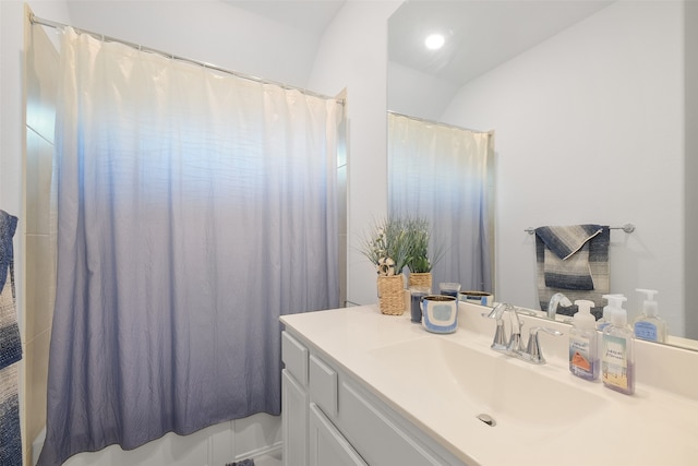 bathroom with vanity and vaulted ceiling