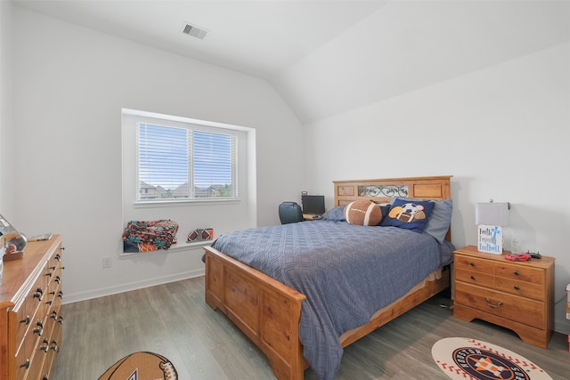 bedroom featuring lofted ceiling and light hardwood / wood-style floors