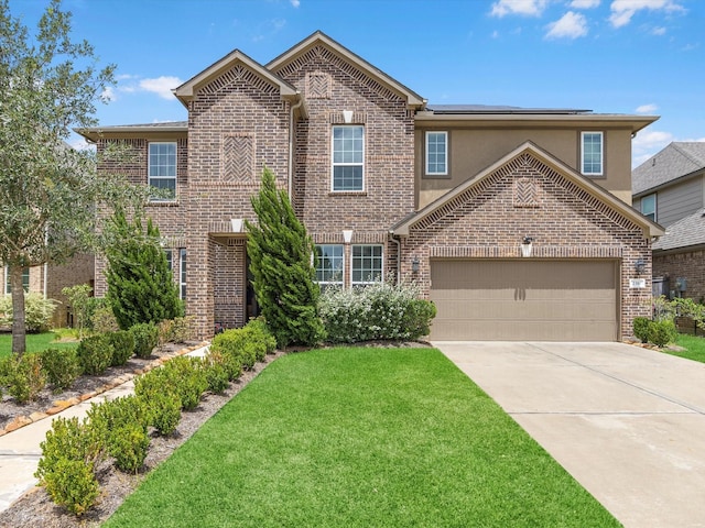 view of front of house featuring a garage and a front yard