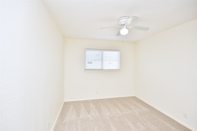 empty room with ceiling fan and light colored carpet