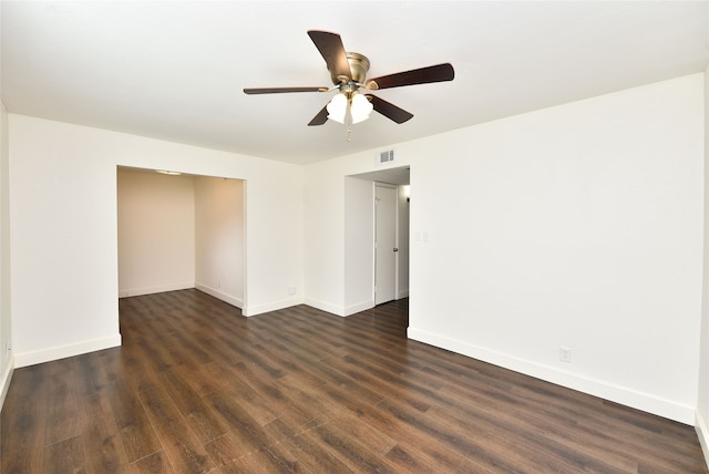 spare room featuring dark wood-type flooring and ceiling fan