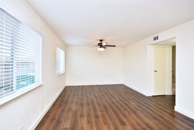 empty room featuring dark wood-type flooring and ceiling fan