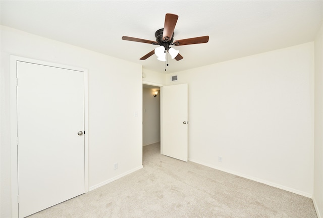 unfurnished bedroom featuring ceiling fan and light carpet