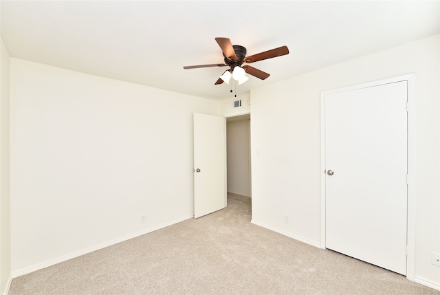 unfurnished bedroom with ceiling fan and light colored carpet