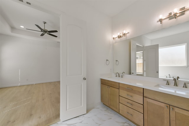 bathroom featuring wood-type flooring, ceiling fan, and vanity