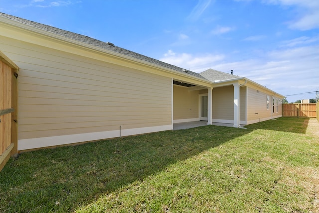 view of home's exterior with a yard and a patio