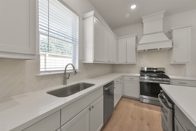 kitchen with sink, stainless steel appliances, and white cabinets