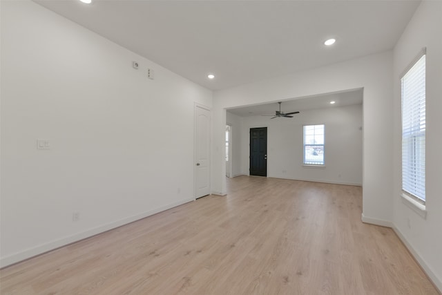 empty room featuring ceiling fan and light hardwood / wood-style flooring