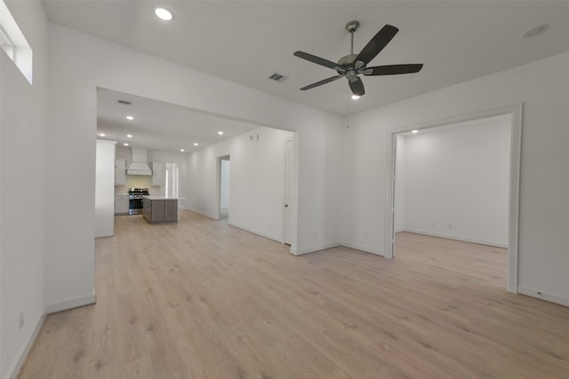 empty room featuring ceiling fan and light hardwood / wood-style floors