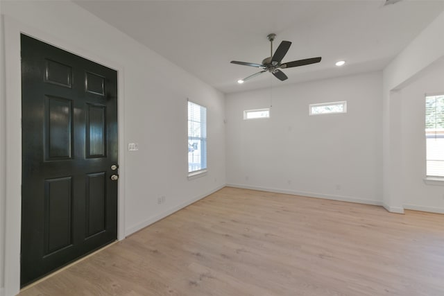 entrance foyer with ceiling fan and light hardwood / wood-style flooring