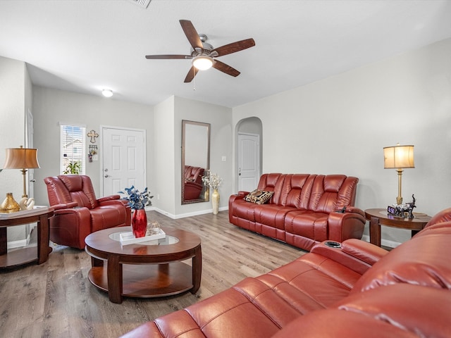 living room with ceiling fan and light hardwood / wood-style floors