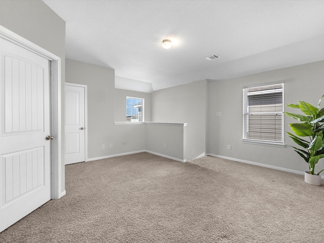 empty room featuring light colored carpet