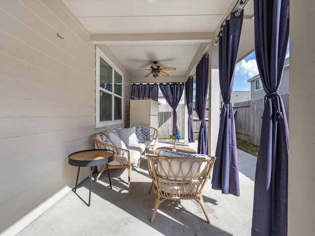 sunroom / solarium featuring ceiling fan