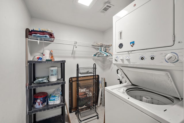 clothes washing area with stacked washer and dryer