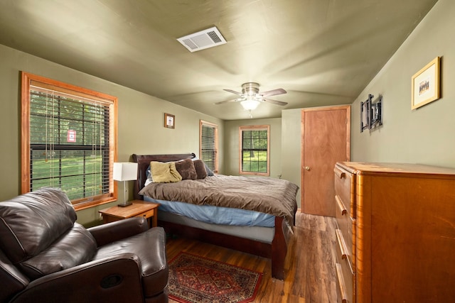 bedroom with dark hardwood / wood-style flooring, ceiling fan, and lofted ceiling