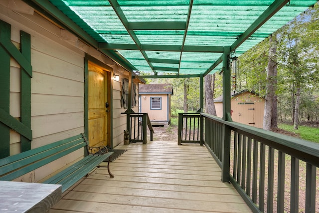 wooden terrace with a storage shed