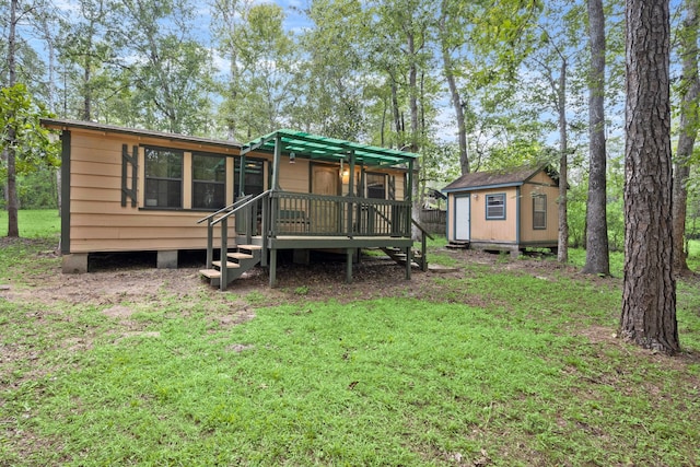 back of house featuring a lawn, a storage shed, and a deck