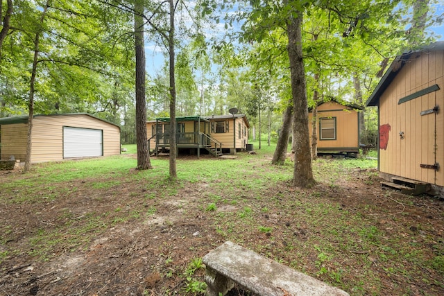 view of yard with a shed and a wooden deck