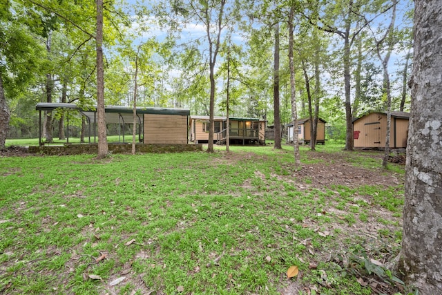 view of yard with a wooden deck and a shed