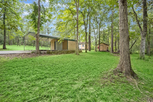 view of yard with a storage unit and a carport